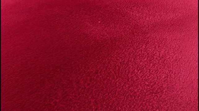 Dark red leather texture background with light gradient and subtle pattern