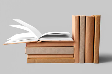 Stack and row of books on grey background