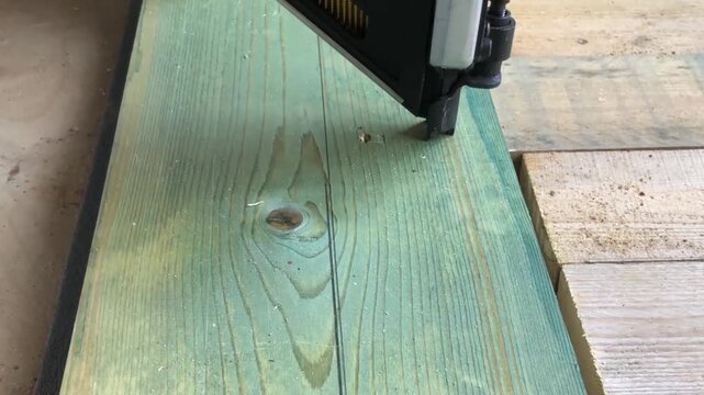 hammering nails with a nail gun at a construction