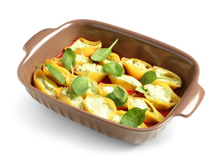 Baking dish of conchiglie pasta stuffed with ricotta, tomato sauce and spinach on white background