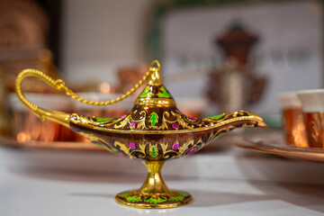 An elegant magic lamp with detailed patterns sits in a cozy setting. the gold and colorful accents add a touch of mystique and charm.