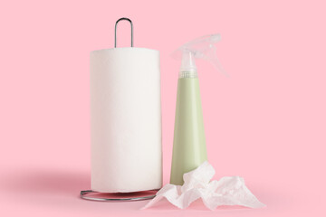 Paper towels with bottle of detergent on pink background