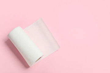 Roll of paper towels on pink background