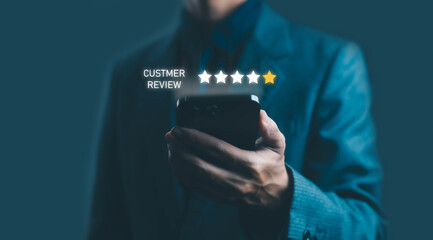 Businessman holding smartphone showing one-star customer review rating symbolizing poor service,...