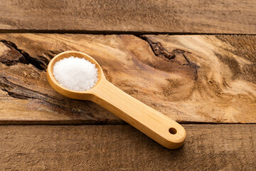 Saccharum officinarum - Fine grains of refined white sugar on a spoon