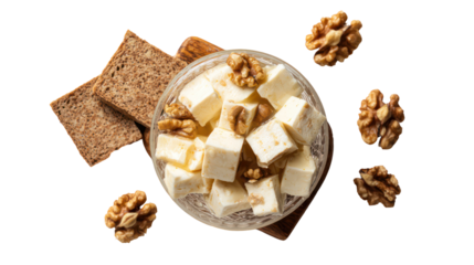 Bowl of feta cheese with walnuts and crackers isolated on transparent background