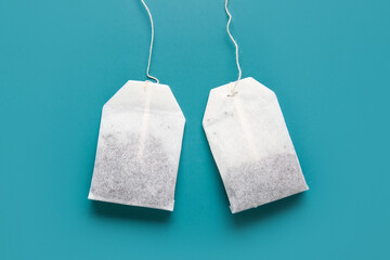 Tea bags on turquoise background