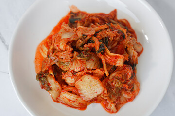 Traditional Korean Kimchi, featuring spicy fermented napa cabbage. This iconic staple offers a unique blend of savory, spicy, and tangy flavors, commonly enjoyed as a versatile side dish.