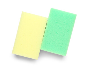 Green and yellow cleaning sponges on white background
