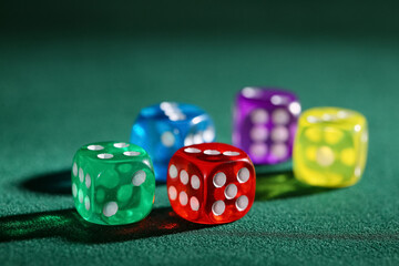Colorful game dices on green background