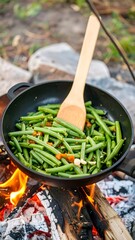 Green beans cooking in a pan over a campfire