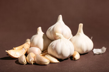 Many fresh garlics on brown background