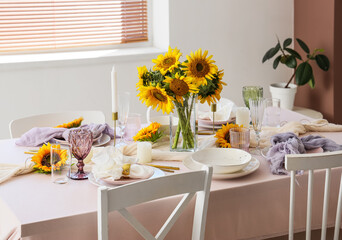Elegant table serving with plates, glasses and beautiful sunflowers