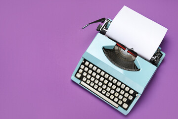 Vintage typewriter with blank paper sheet on purple background