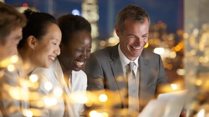 Happy diverse business team laughing during a successful night meeting in a modern office with city lights background, professional collaboration. - Powered by Adobe