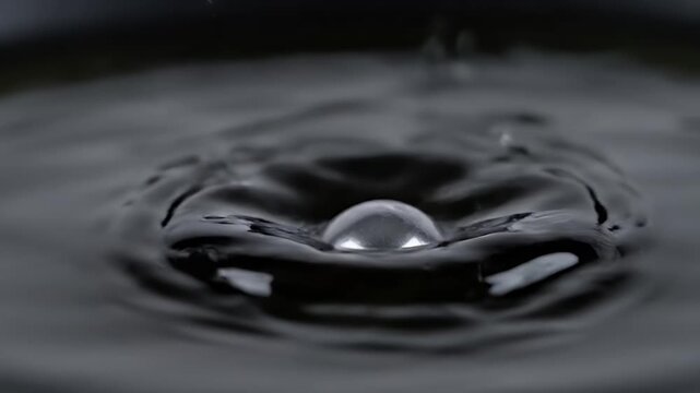 High-Speed Water Droplet Impact Visuals: Captivating Ripple Effects and Crown Formation Under Black Background 90 frames per second