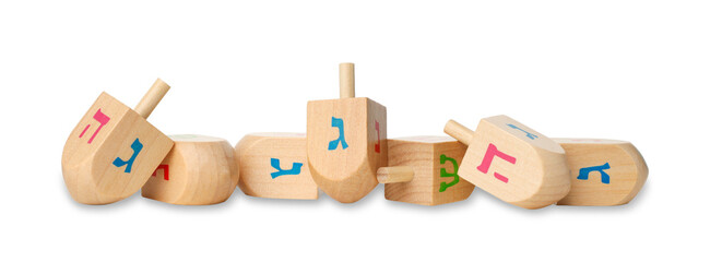 Colorful wooden dreidels with Hebrew letters in a row, isolated, PNG