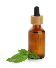 Bottle of basil essential oil isolated on white background, closeup