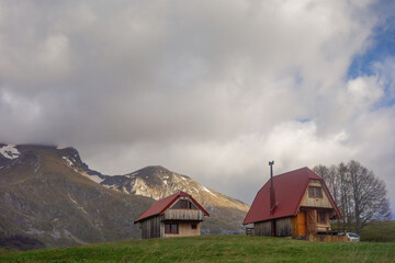 country cottages facing mountains of Durmitor in Zabljak, Montenegro
