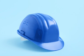 Blue hardhat on color background