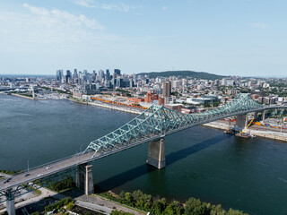 Obraz premium Aerial view of Montreal city skyline and the Jacques Cartier Bridge over the St. Lawrence. g.