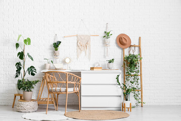 Interior of office with workplace, ladder and houseplants