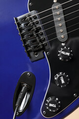 Naklejka premium Modern electric guitar on beige background, closeup
