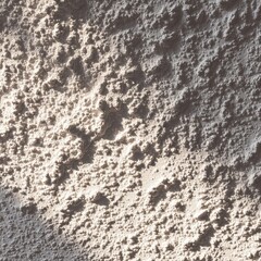 A close up of a white wall with a clock