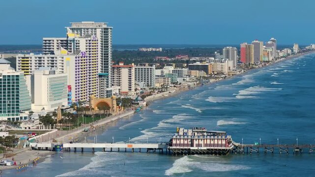 Main Street Pier in Daytona Beach, Florida. American Atlantic coast location with active tourist development and beachfront urban planning.