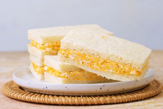 Tamago Sando egg sandwich on ceramic plate, delicious Japanese comfort food breakfast.