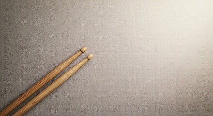 Angled Drumsticks on Textured Canvas: Minimalist Musical Instrument Concept