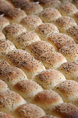Freshly baked bread rolls lined on a tray