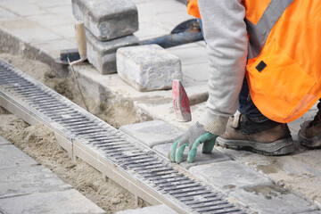 Worker laying bricks on a construction site in the morning