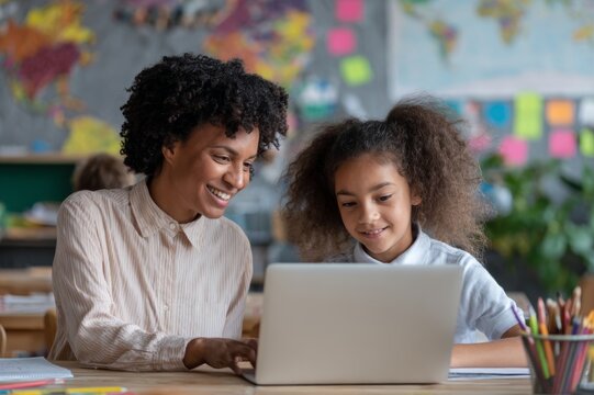 Online Learning Session with Afro-American Teacher and Young Student on Laptop