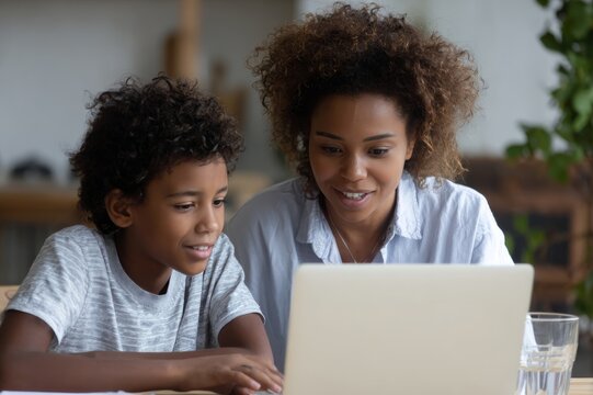 Online Learning Session with Afro-American Teacher and Young Student on Laptop