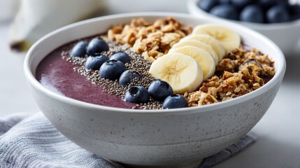 Colorful acai bowl with banana, blueberries, chia seeds, and granola, artfully arranged in bowl, neutral background, soft natural lighting edges.