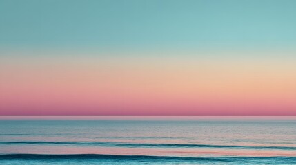 Obraz premium Horizon divides ocean and sky in soft pastel sunset hues.