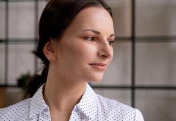 Portrait of a young woman in an office. Business and people concept.