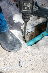 Jackhammer Breaking Concrete to Access Water Pipe
