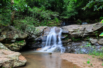 Beautiful Small Waterfall in Green Forest in jungle at Huay U-Mong Nature Trail Chiang Mai, Northern Thailand