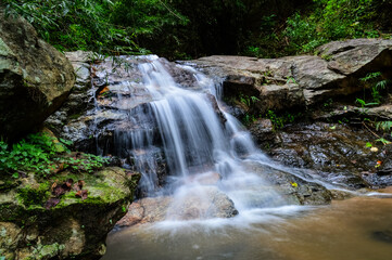 Beautiful Small Waterfall in Green Forest in jungle at Huay U-Mong Nature Trail Chiang Mai, Northern Thailand