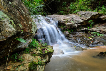 Beautiful Small Waterfall in Green Forest in jungle at Huay U-Mong Nature Trail Chiang Mai, Northern Thailand