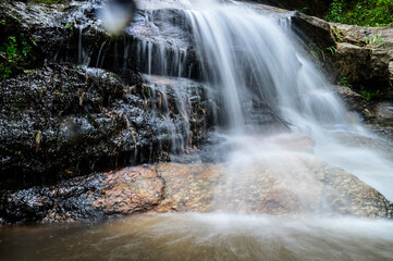 Beautiful Small Waterfall in Green Forest in jungle at Huay U-Mong Nature Trail Chiang Mai, Northern Thailand
