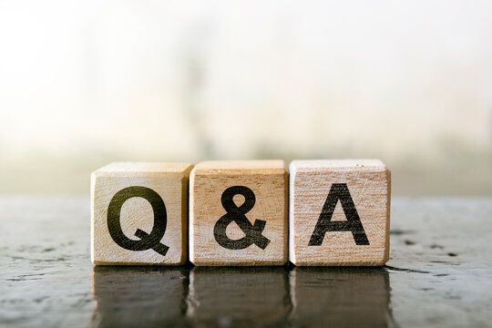 Wooden blocks with letters Q and A representing a question and answer