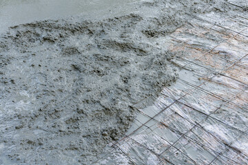 Wet Concrete Being Poured Over Wire Mesh Reinforcement