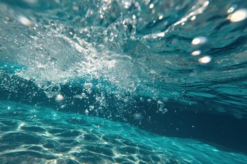 Obraz premium Slow motion underwater bubbles rising to the surface, creating a mesmerizing display of light and movement in clear blue water