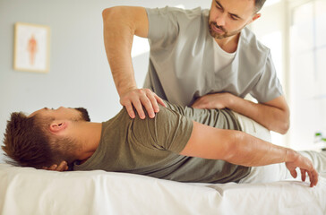 Physical therapy session. Professional chiropractor or physical therapist performs manual therapy...
