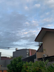 Peaceful twilight sky over suburban homes, capturing the serene beauty of residential life at dusk with a subtle hint of national pride