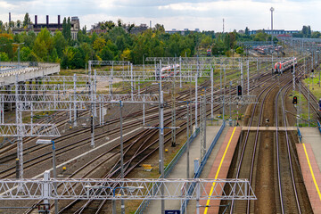 Poznan Glowny railway station, view of train tracks, catenary network and platforms with multiple electric trains