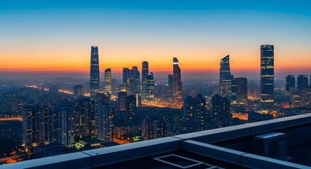 A cityscape view at dusk with illuminated skyscrapers and buildings under a colorful orange and blue sky, seen from a rooftop perspective.